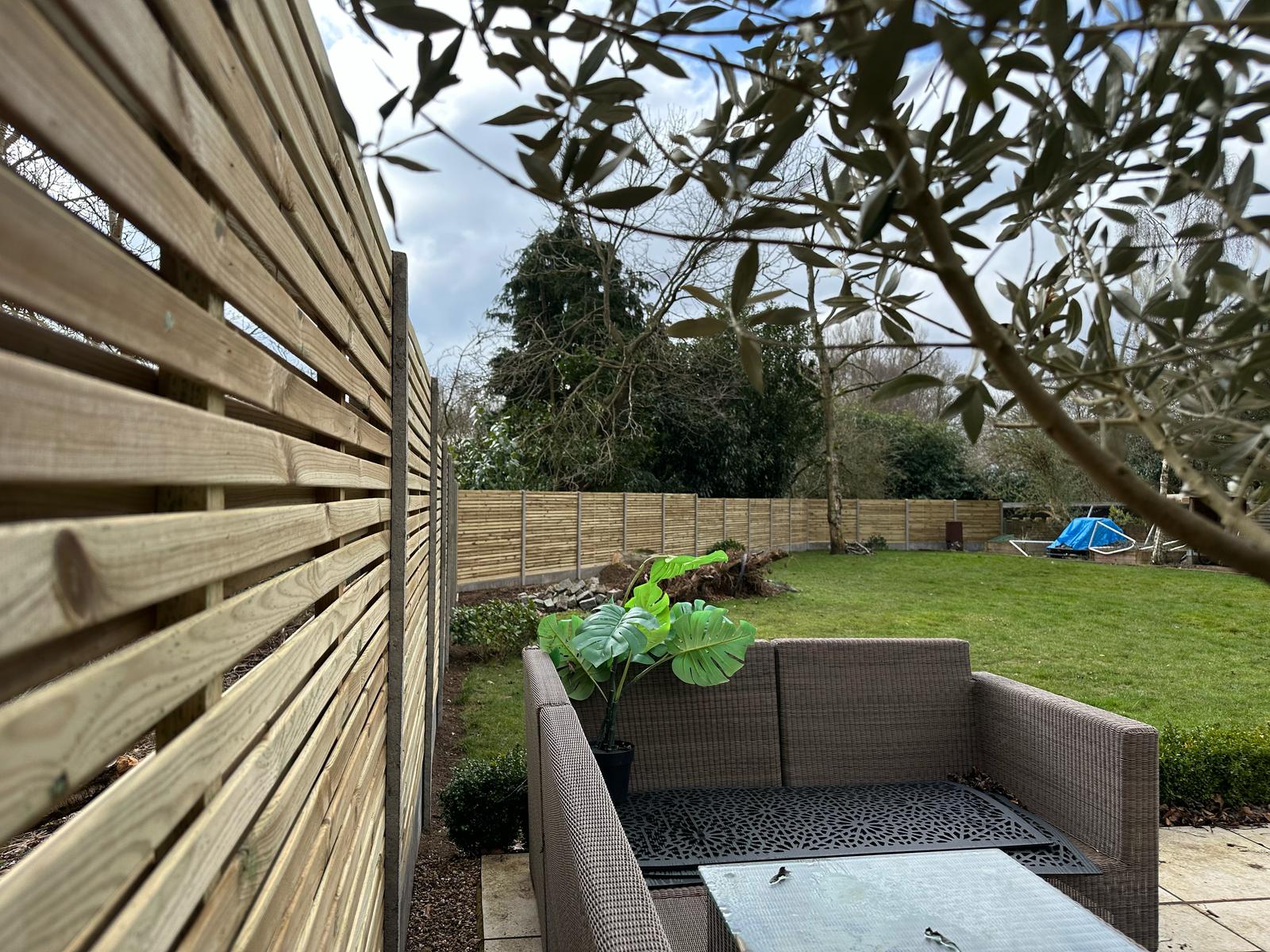 Slatted fencing with rattan furniture